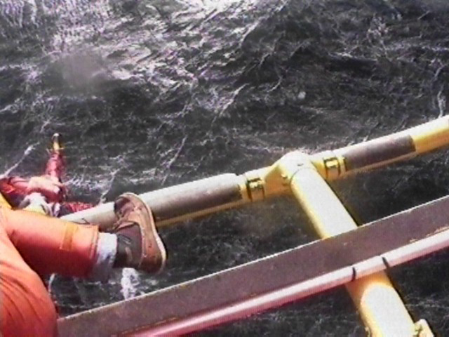 A sailor falls from rescue helicopter harness into Cook Strait.