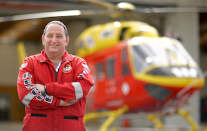 dave greenberg in front of rescue helicopter